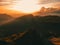 Man silhouette stay on a mountain top in dolomites during sunset