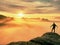 Man silhouette stay on sharp rock peak. Satisfy hiker enjoy view. Tall man on rocky cliff