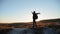 Man silhouette striving for success hand to hand walking tourist hiking adventure climbers sunset climb the mountain