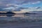 Man sillhoutte walking into sunset of lake Bonneville Salt Flats, Wendover, Western Utah, USA, America. Beautiful summits of