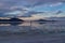 Man sillhoutte walking into sunset of lake Bonneville Salt Flats, Wendover, Western Utah, USA, America. Beautiful summits of