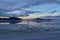 Man sillhoutte walking into sunset of lake Bonneville Salt Flats, Wendover, Western Utah, USA, America. Beautiful summits of
