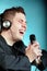 Man singing into microphone happy karaoke signer