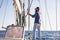 Man sit on a sail boat travel the ocean and enjoy freedom lifestyle - concept of sailing and having fun during summer holiday