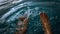 A man siting having fun splashing water from the swimming pool at hotel with his feet during the summer