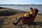 Man sits on armchair outdoors