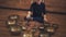 A man sits in the lotus position and plays on the Tibetan singing bowls