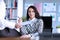 Man sits in an office on table in front woman