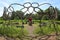 Man sits in outdoor sculpture made of interlocking butterfly pattern in Burnham Wildlife Corridor Chicago