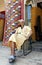 A man sits outside his carpet shop in Meknes, Morocco.