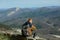 Man sits on the slope of mountain