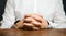 A man sits at the table with folded arms. Ready to listen to news. Serious talk. Calmly. Communication and body expressions