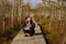 A man sits on a wooden path in a swamp in Yelnya, Belarus