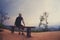 Man sitting alone on bench looking at landscape