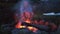 Man sitting alone at Night campfire of indonesian family fun camping at bromo mountain forest conservation area with campfire