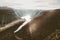 Man sitting alone on Trolltunga cliff edge in Norway