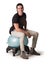 Man sitting on balance ball chair against white background