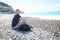 Man Sitting On Beach, Texting On His Phone