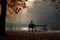 Man sitting on a bench in the autumn park. Conceptual image, rear view of a solitary person sitting on a bench in an autumn park