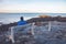 Man sitting on a bench on Marginal Way path along the rocky coast of Maine in Ogunquit during winter