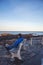 Man sitting on a bench on Marginal Way path along the rocky coast of Maine in Ogunquit during winter