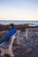 Man sitting on a bench on Marginal Way path along the rocky coast of Maine in Ogunquit during winter