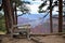 Man Sitting on Bench Overlooking Canyon