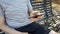 Man sitting on a bench reading phone message