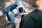 Man sitting on bench with tablet and professional camera