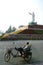 Man sitting on a bike under mao\'s statue, china