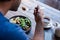 Man sitting at a bistro table eating delicious salad