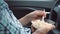 Man, sitting in a car, eats a salad with mayonnaise from plastic disposable dishes