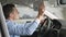 Man sitting in the car lowering the visor