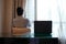 Man sitting on the chair with laptop on the hotel work desk