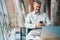 Man is sitting in chair with phone in his hand