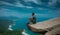Man sitting on a cliff admiring the beautiful ocean view, Pedra do Telegrafo, Rio de Janeiro, Brazil