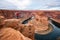 Man sitting on a cliff over Colorado river in Horseshoe bend canyon