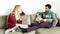 Man sitting on comfortable couch speaking to handsome woman