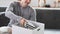 Man sitting on couch preparing personal stuff for moving into new house.