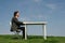 Man sitting at desk, outdoors