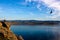 Man sitting on the edge of a cliff above Lake Baikal