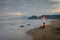 A man is sitting and enjoying the moment on Karang Hawu Beach, West Java, Indonesia