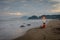 A man is sitting and enjoying the moment on Karang Hawu Beach, West Java, Indonesia