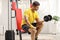 Man sitting on a fitness machine and exercising with a dumbbell at home