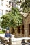 Man sitting in front of the Panagia Kapnikarea church