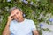 Man sitting in front of Plumbago capensis