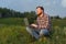 Man sitting on the grass with a laptop