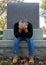 Man sitting at gravesite