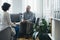 Man sitting on a gray sofa during a meeting with a psychotherapist