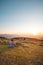 Man sitting by a haystack relaxes and lets the stress leave his body as he watches the sun go down. An hour alone. Trinec, Czech